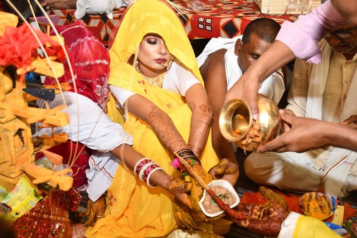 Family members performing a haldi ritual
