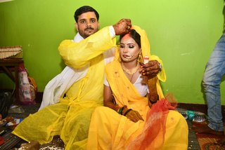 Couple sharing a playful haldi portrait