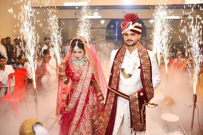Wedding couple walking through a sparkler celebration